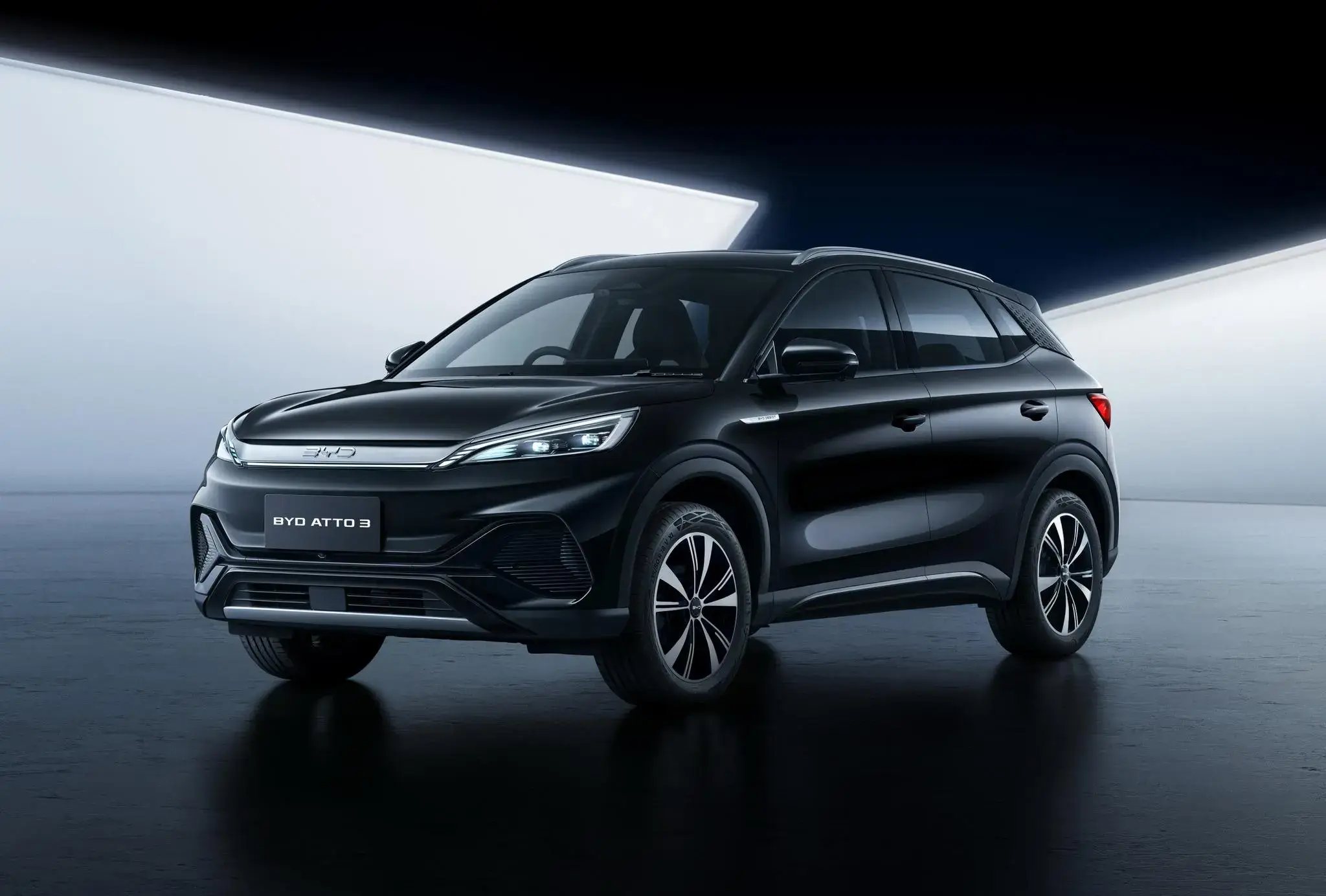 Black BYD ATTO 3 ULTRA electric crossover SUV with sleek design and alloy wheels in dramatic studio lighting