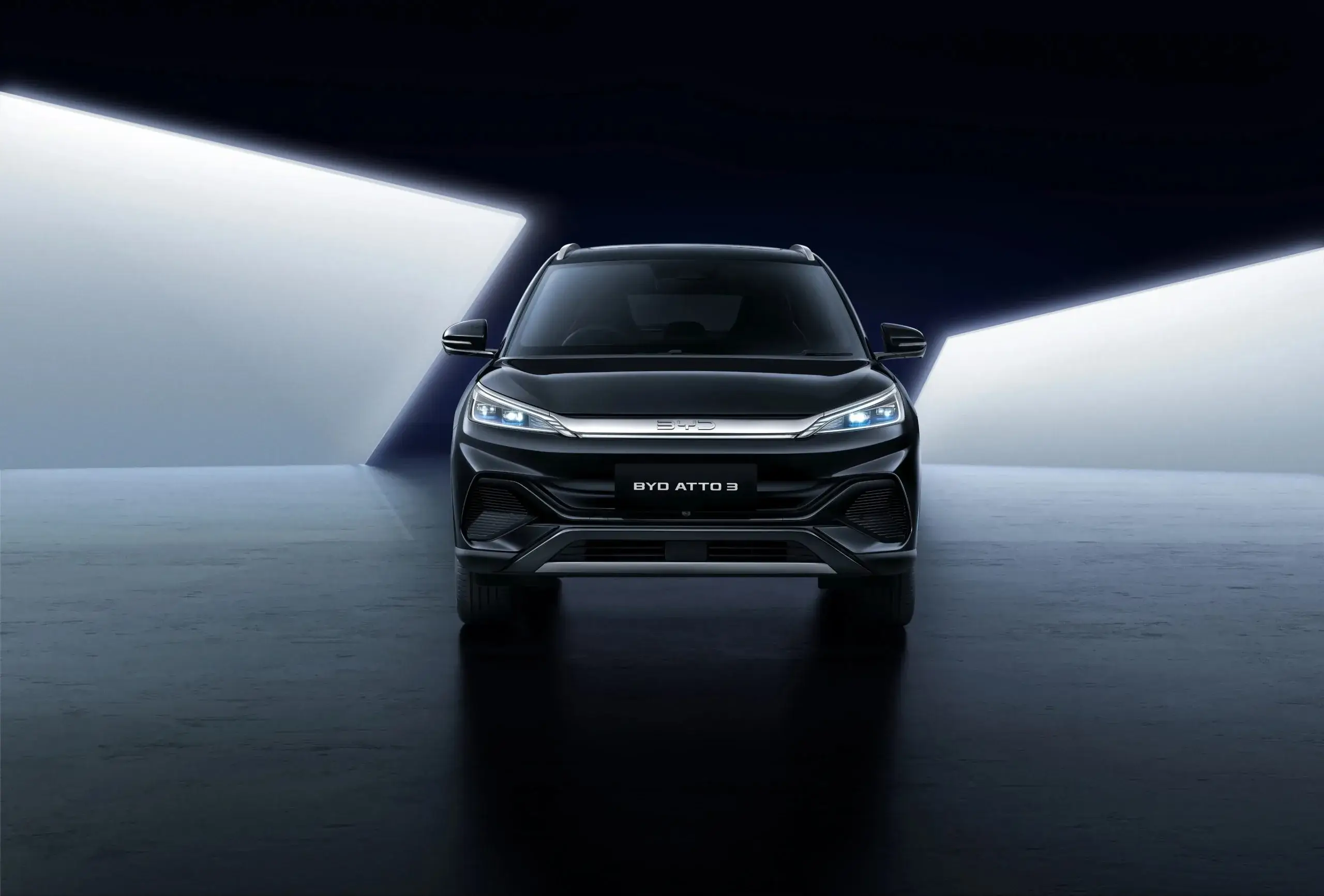 Front view of black BYD ATTO 3 ULTRA electric SUV with LED headlights in modern studio lighting environment